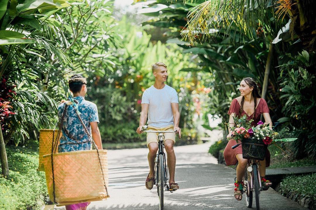 La pareja en bicicleta entre el verde de Bali